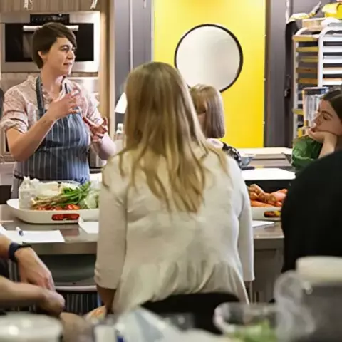 Chef prepares food for students during the course