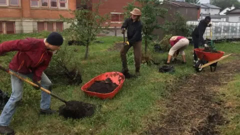 Volunteers help insall OFRE Micro Orchard project